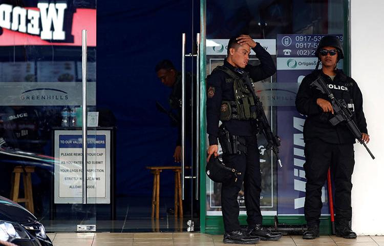 Security forces are seen in San Juan, the Philippines, on March 2, 2020. Police recently arrested journalist Frenchiemae Cumpio on firearms charges. (Reuters/Eloisa Lopez)