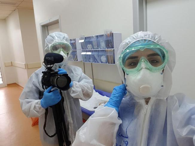 Freelance photographer and videographer Zmnako Ismael (left) is seen covering the COVID-19 pandemic. (Photo via Ismael)