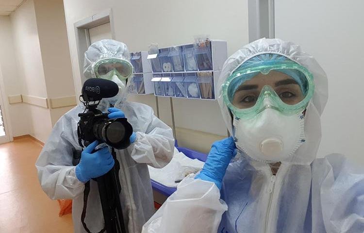 Freelance photographer and videographer Zmnako Ismael (left) is seen covering the COVID-19 pandemic. (Photo via Ismael)