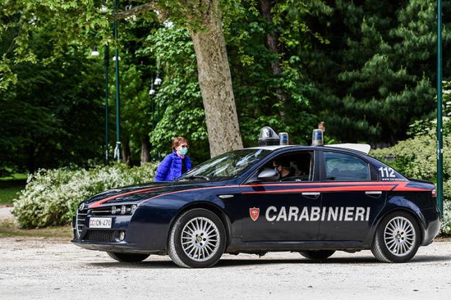 A police car is seen in Milan, Italy, on May 4, 2020. Unidentified attackers recently shot at Italian journalist Mario De Michele’s home. (AFP/Miguel Medina)