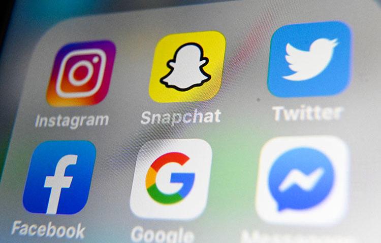 A picture taken on October 1, 2019, shows the logos of mobile apps Instagram, Snapchat, Twitter, Facebook, Google, and Messenger. (AFP/Denis Charlet)