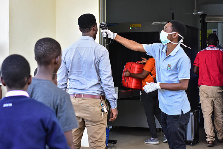 People are seen in Namanga, Tanzania, on March 16, 2020. Tanzanian authorities recently suspnded the Mwananchi newspaper from publishing online for six months over a COVID-19 report. (AFP/Filbert Rweyemamu)