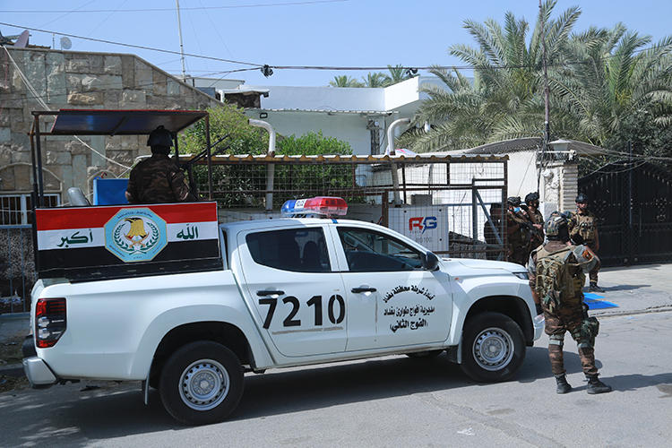 Iraqi security forces stand guard outside the offices of the MBC 1 TV channel in Baghdad, Iraq, on May, 18, 2020. The office was attacked by protesters on May 18.