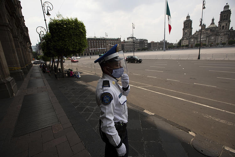 A police officer is seen in Mexico City on April 25, 2020. The Mexican Interior Secretariat recently threatened two news companies over their coronavirus coverage. (AP/Fernando Llano)