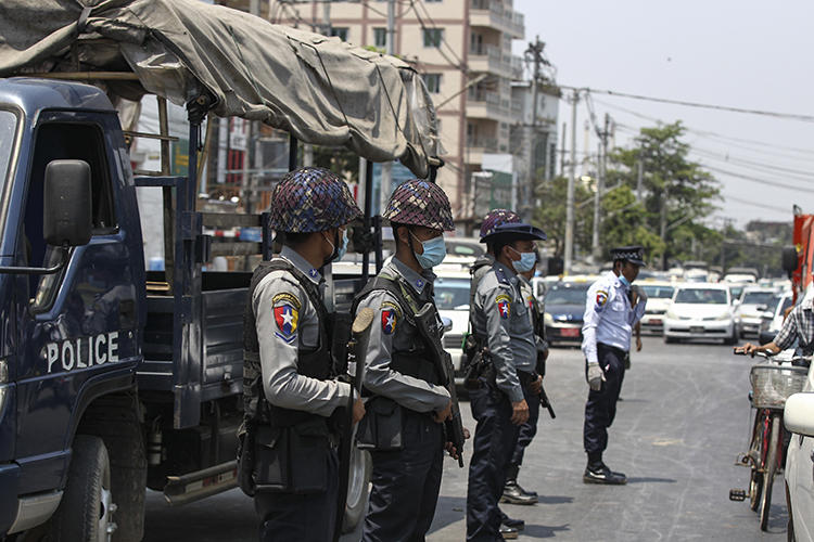 Police officers are seen in Yangon, Myanmar, on April 17, 2020. Editor Khaing Mrat Kyaw is facing terrorism charges and is in hiding. (AP/Thein Zaw)