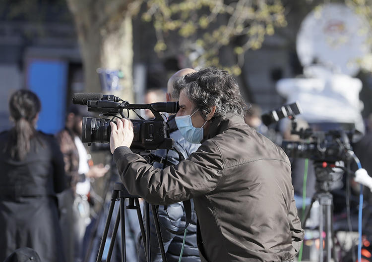 Journalists are seen in London on April 7, 2020. CPJ recently partnered with groups launching surveys to track the COVID-19 pandemic's impact on journalism. (AP/Kirsty Wigglesworth)