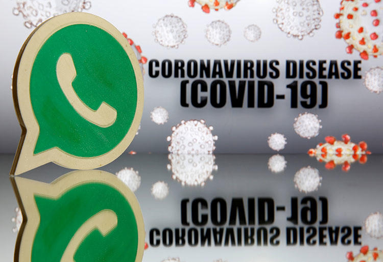 A 3D-printed WhatsApp logo is seen in front of displayed coronavirus disease (COVID-19) sign in this illustration taken March 19, 2020. (Reuters/Dado Ruvic/Illustration)