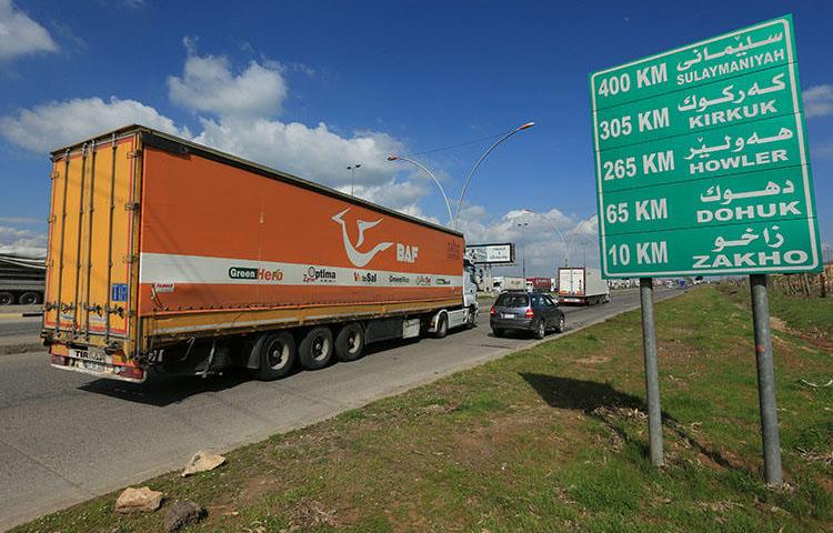 A truck leaves Ibrahim Al-Khalil complex to a warehouse in Zakho outskirts, following the outbreak of COVID-19, in Dohuk province, Iraqi Kurdistan, on April 2, 2020. On May 16, security forces in Iraqi Kurdistan detained 8 journalists in Duhok covering a protest, and charged 4. (Reuters/Ari Jalal)