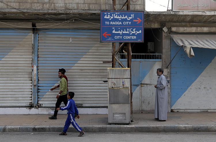 People are seen in Tal Abyad, Syria, on October 17, 2019. Authorities in the region recently suspended reporter Vivian Fatah’s press credentials for two months. (Reuters/Khalil Ashawi)