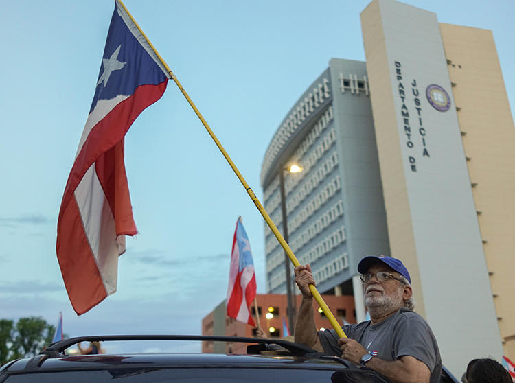 Protesters are seen in front of the Department of Justice in San Juan, Puerto Rico, on July 29, 2019. The department recently subpoenaed Facebook for information from student news outlets on the island. (Angel Valentin/Getty Images via AFP)