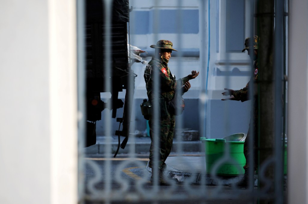 A soldier is pictured behind a gate.