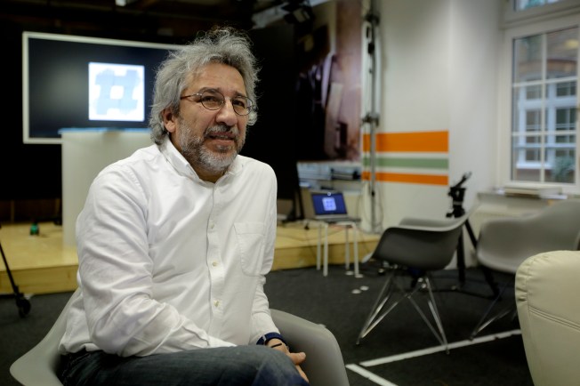 Turkish editor Can Dündar sitting in chair