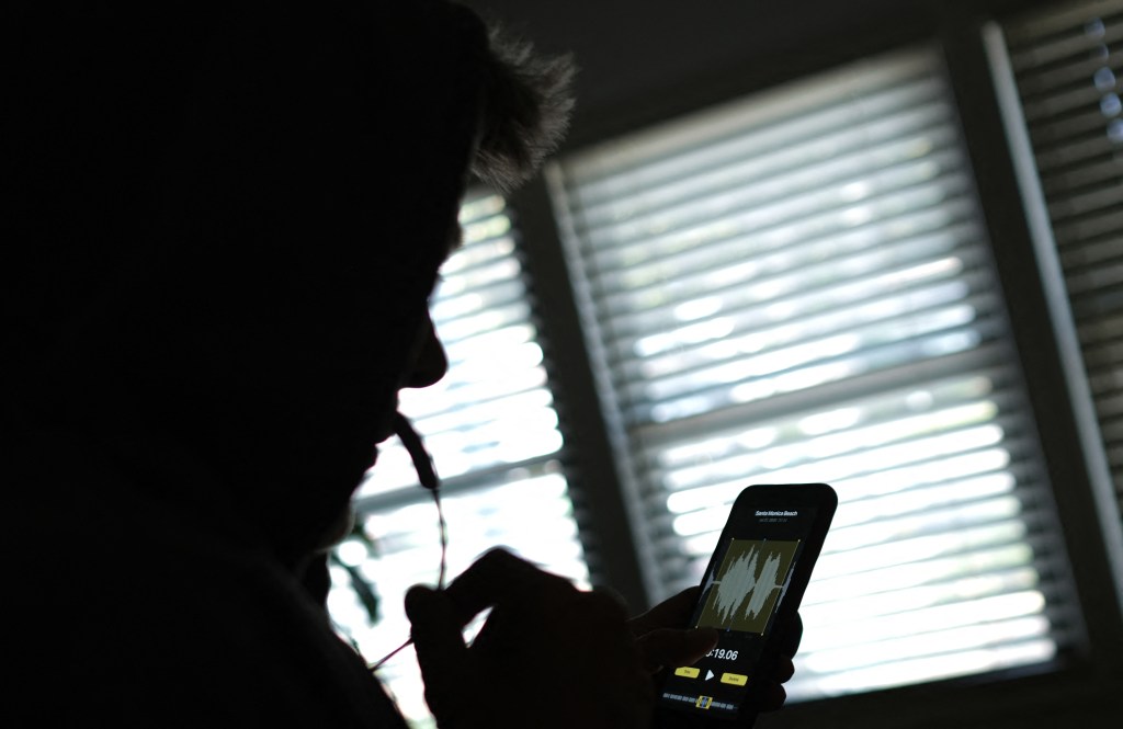 This illustration image created on June 9, 2023, shows a person using a smartphone to record a voice message in Los Angeles.