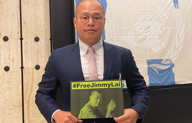 Sebastien Lai, son of Hong Kong media tycoon Jimmy Lai, holds a sign calling for the release of his father on the sidelines of the United Nations Human Rights Council in Geneva, Switzerland, September 27, 2023.