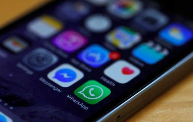 Icons for the encrypted apps WhatsApp and Messenger are seen on an iPhone in Britain on March 27, 2017.