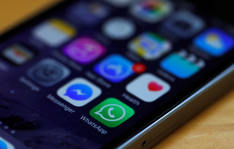Icons for the encrypted apps WhatsApp and Messenger are seen on an iPhone in Britain on March 27, 2017.