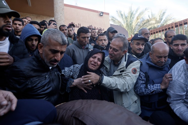 Relatives of Al-Jazeera cameraman Samer Abu Daqqa, who was killed on December 15, 2023, by an Israeli airstrike, mourn his death during his funeral in the town of Khan Younis, southern Gaza Strip, on December 16, 2023. (AP Photo/Mohammed Dahman)