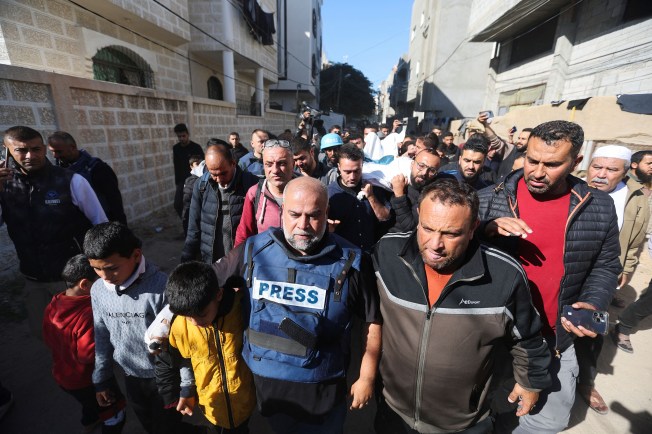 Al-Jazeera journalist Wael Al Dahdouh (center) attends the January 7, 2024, funeral of his son, Palestinian journalist Hamza Al Dahdouh.