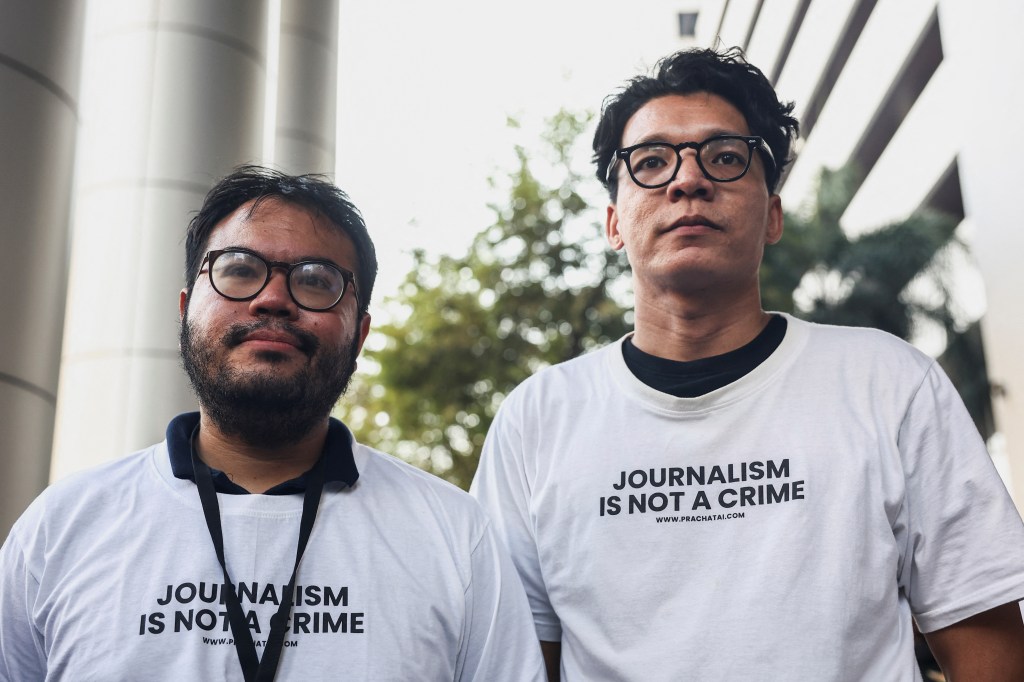 Thai reporter Nattaphol Meksobhon (left) and photographer Nattaphon Phanphongsanon are seen after receiving bail in Bangkok, Thailand, on February 13, 2024.