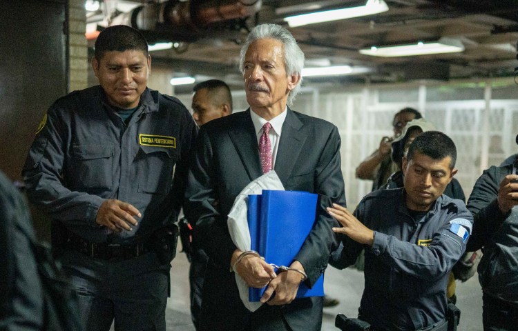 Police escort journalist José Rubén Zamora to court in Guatemala City on June 14, 2023.