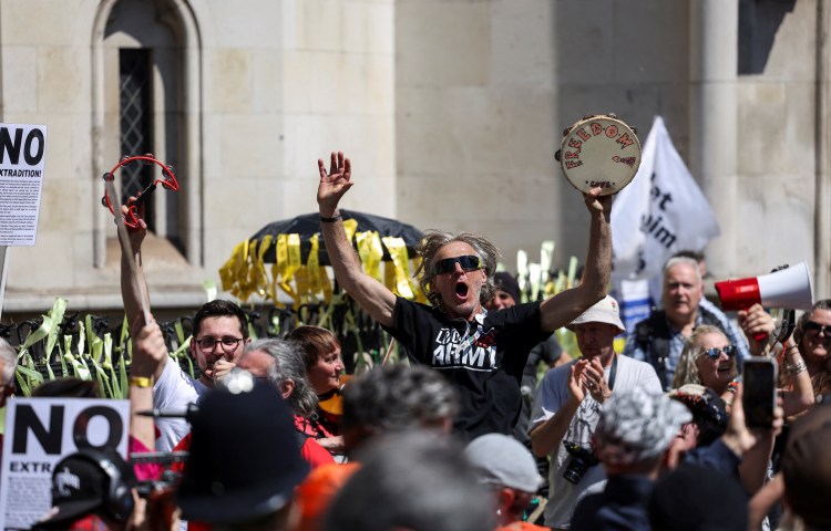 Supporters of Julian Assange celebrate the verdict, outside of the Royal Court of Justice, on the day of an extradition hearing of the WikiLeaks founder, in London, Britain, May 20.