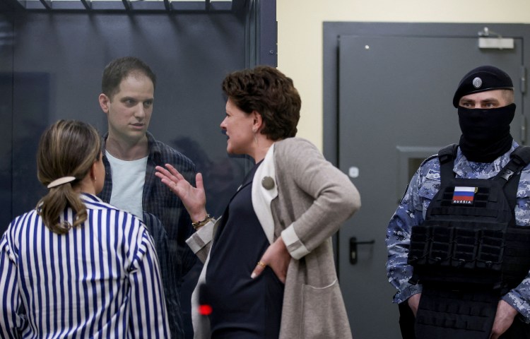 Wall Street Journal reporter Evan Gershkovich speaks with his lawyers before a court hearing in Moscow on April 23, 2024. (Photo: Reuters/Tatyana Makeyeva)