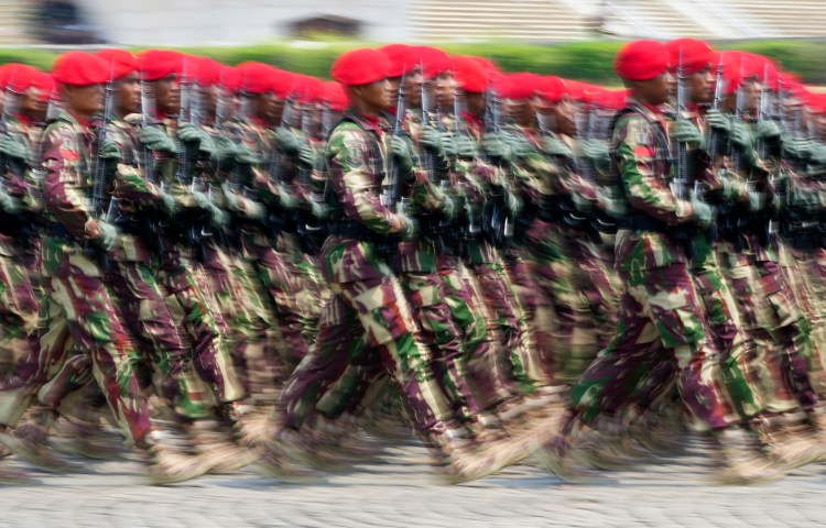 Soldiers march during a parade marking the 78th anniversary of the Indonesian Armed Forces in Jakarta on October 5, 2023. Indonesian journalist Sempurna Pasaribu and three family members died in a house fire days after Pasaribu published reports alleging high-level military involvement in an illegal gambling operation. (AP Photo/Tatan Syuflana)