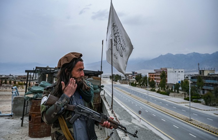 A Taliban fighter is positioned on the rooftop of the main gate of Laghman University in Mehtarlam, Laghman province in February 2022. On June 13, 2024, Taliban officials raided and shut down Mehtarlam radio station Kawoon Ghag. (Photo: AFP/Mohd Rasfan)