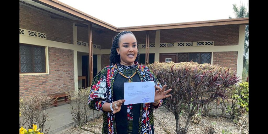 Journalist Florianne Irangabiye photographed on August 16, 2024, outside Bubanza Prison holding a certificate authorizing her release. (Photo: Credit withheld)