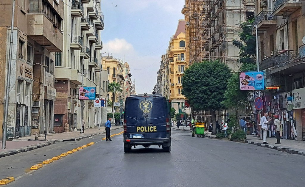 A police vehicle drives around Cairo's Tahrir Square in November 2022. Since March 2024, Egyptian authorities have arrested four journalists and taken them to unknown locations. CPJ and other rights groups have called for their immedate release. (Photo: AFP/ Khaled Desouki)