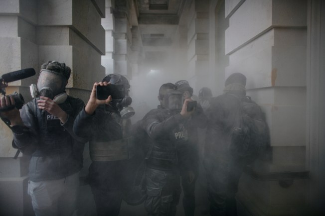 Journalists report from the U.S. Capitol as pro-Trump protesters stormed the building on January 6, 2021, to contest the certification of the 2020 presidential election. (Photo: Reuters/Ahmed Gaber)