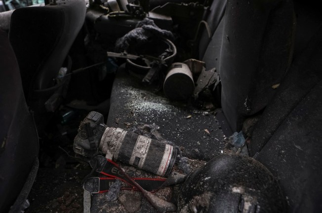 A journalist's camera covered in dirt and broken glass lies on the back seat of a damaged car outside the Park Hotel, which was struck by Russian missles in central Kharkiv, Ukraine, in January 2024. (Photo: Reuters/Sofiia Gatilova)