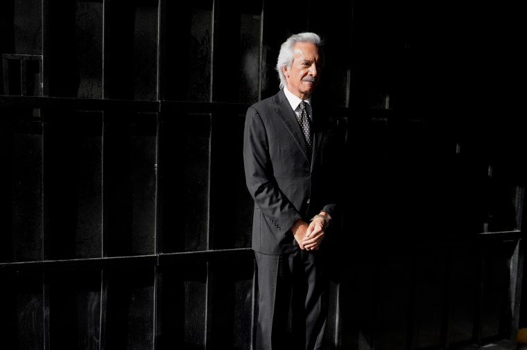 Guatemala's José Rubén Zamora, founder of El Periodico newspaper, waits in handcuffs ahead of a court hearing in Guatemala City on August 26.