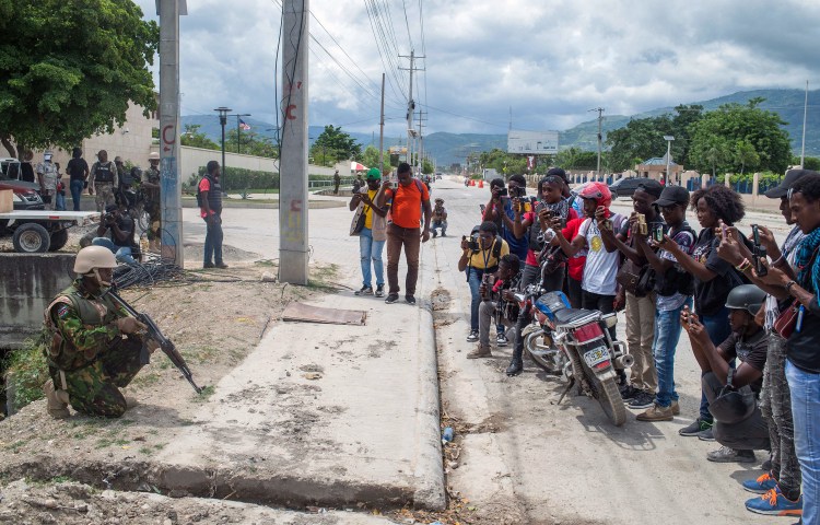 Journalists photograph and film Kenyan police as they guard the U.S. Embassy in the Haitian capital of Port-au-Prince on July 5, 2024. Haiti and Israel rank as the world’s worst offenders in letting journalists’ murderers go unpunished, according to CPJ’s 2024 Global Impunity Index. (Photo: AFP/Clarens Siffroy)