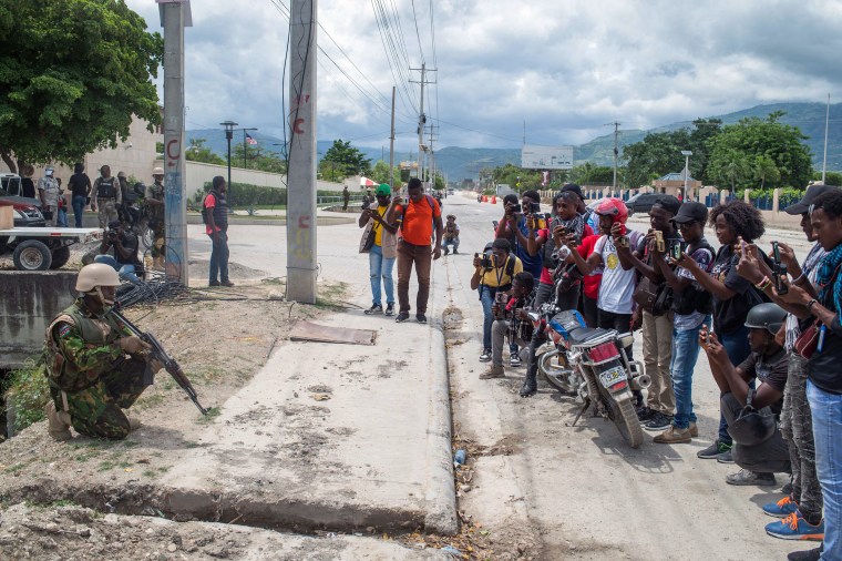 Journalists photograph and film Kenyan police as they guard the U.S. Embassy in the Haitian capital of Port-au-Prince on July 5, 2024. Haiti and Israel rank as the world’s worst offenders in letting journalists’ murderers go unpunished, according to CPJ’s 2024 Global Impunity Index. (Photo: AFP/Clarens Siffroy)