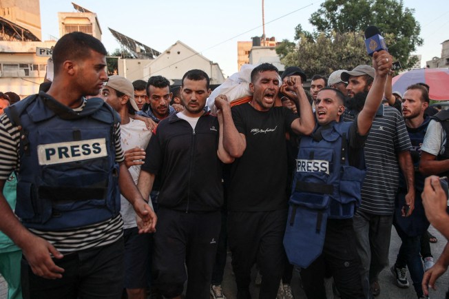 Mourners carry the body of Al Jazeera Arabic journalist Ismail Al Ghoul, killed along with camera operator Rami Al Refee in an Israeli drone strike on July 31, 2024. The two were among five journalists in the region deliberately targeted by Israeli forces. (Photo: AFP/Omar Al-Quattaa)