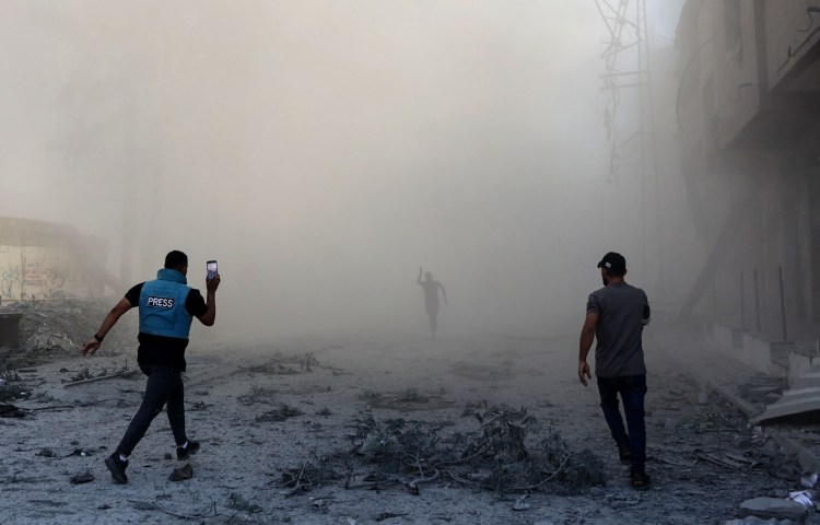 A journalist and others rush toward the scene of an explosion following an Israeli strike on the outskirts of Gaza City, on September 1, 2024. (Photo: AFP/Omar Al-Qattaa)