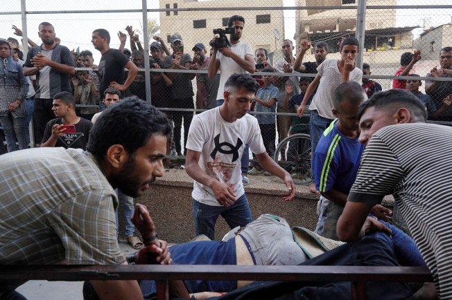 Journalists and local residents watch the arrival of victims wounded or killed in Israeli bombardment near Khan Yunis into Nasser hospital in the southern Gaza city on July 9, 2024. The strike hit a school turned shelter, killing at least 29 people, a local hospital source said. (Photo: AFP/ Bashar Taleb)