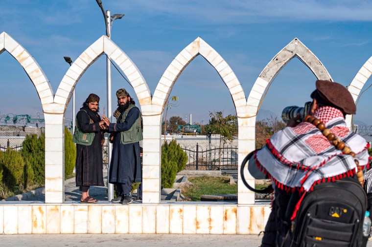 A street photographer takes photos of Taliban security personnel in Kabul on November 25, 2024. (Photo: AFP/Wakil Kohsar)