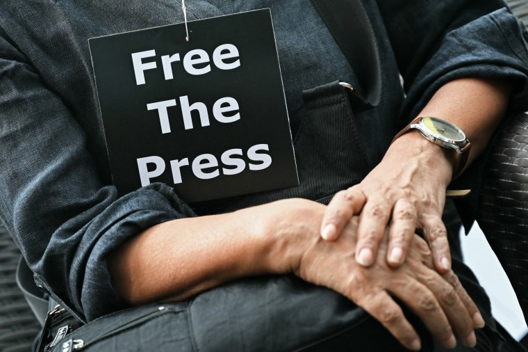 A member of the media wears a placard during an October 4, 2023, demonstration in New Delhi over the arrests of people linked to a news website. In 2024, CPJ provided prison support grants to 58 journalists jailed in connection with their work. (Photo: Arun Sankar/AFP)