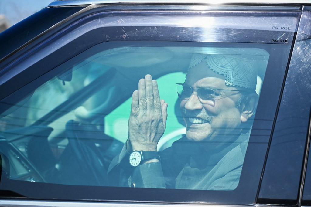 Pakistan's President Asif Ali Zardari gestures from a car in Nawabshah on February 8, 2024. (Photo: AFP)