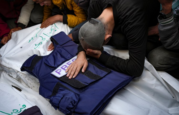 A relative mourns over the body of one of five Palestinian journalists killed by an Israeli airstrike in Gaza City's Al-Aqsa Hospital on December 26, 2024.