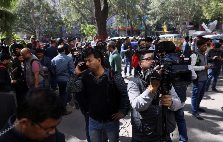 Members of the media work outside a building having BBC offices, where income tax officials are conducting a search, in New Delhi, India, February 14, 2023. REUTERS/Anushree Fadnavis