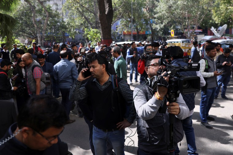 Members of the media work outside a building having BBC offices, where income tax officials are conducting a search, in New Delhi, India, February 14, 2023. REUTERS/Anushree Fadnavis