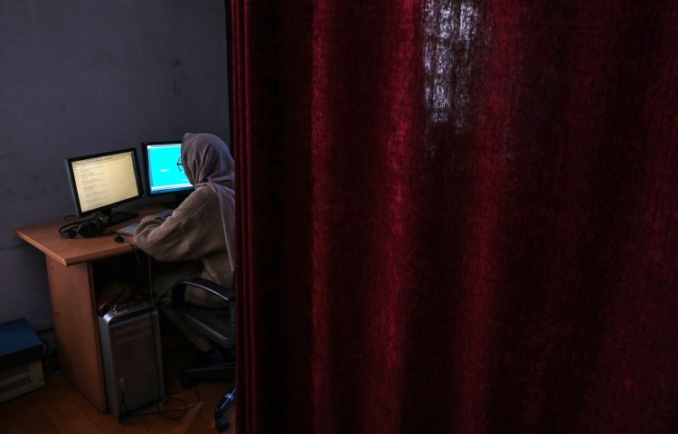 This picture taken on November 28, 2021, shows a woman working at Radio Begum in Kabul, Afghanistan. Taliban agents raided the station on February 4, 2025, suspended broadcast operations, and detained two media workers. (Photo: AFP/Hector Retamal)