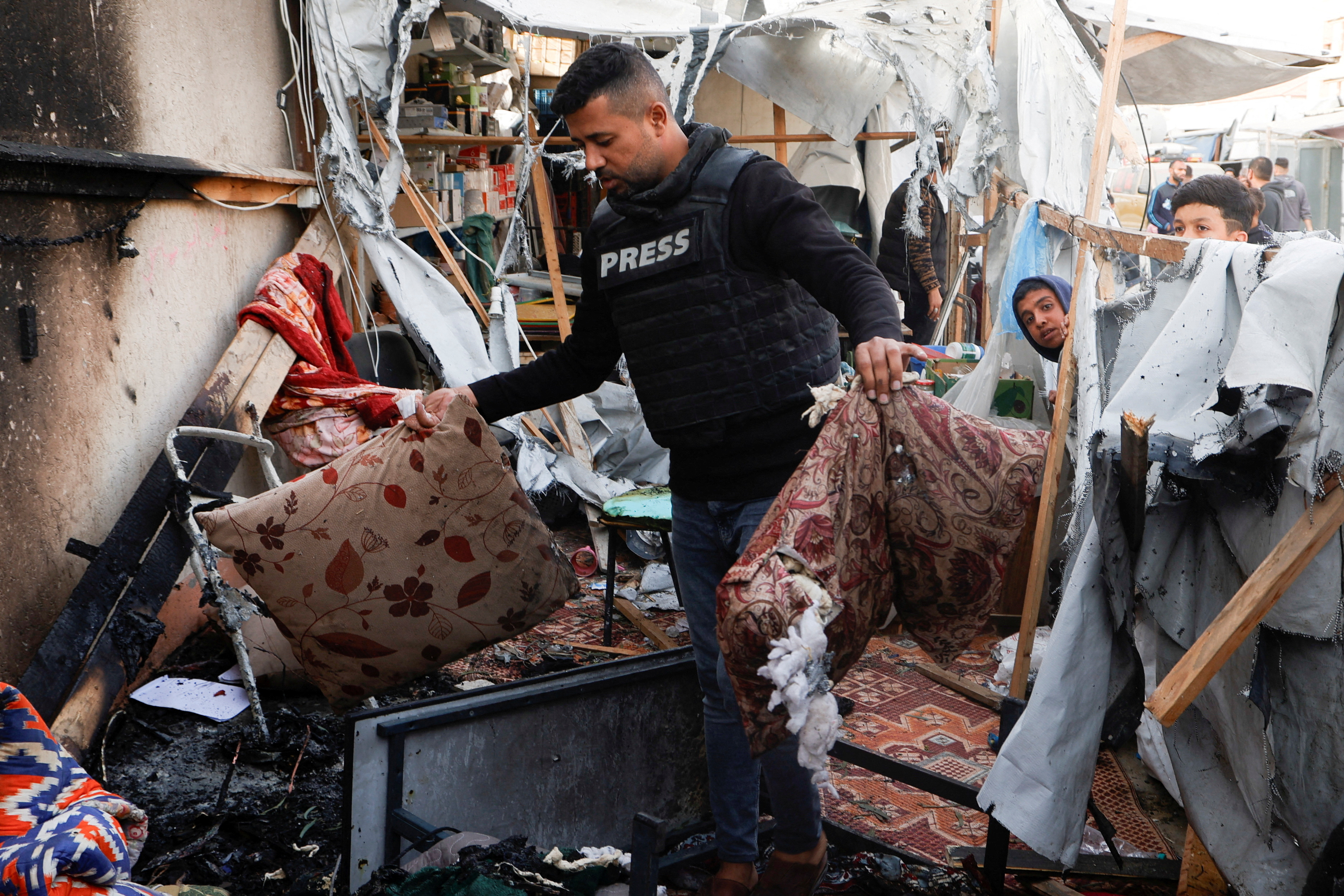 Palestinians inspect damage to a tent housing journalists after it was hit by an Israeli strike in Khan Yunis in southern Gaza on April 7, 2025. (Photo: Reuters/Hatem Khaled)