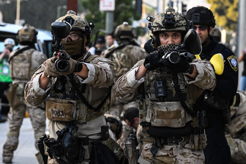 U.S. Customs and Border Protection agents hold up less-lethal weapons in front of the Federal Building during ongoing demonstrations in response to federal immigration operations in downtown Los Angeles, California on June 12, 2025. (Photo: AFP/Ronaldo Schemidt)