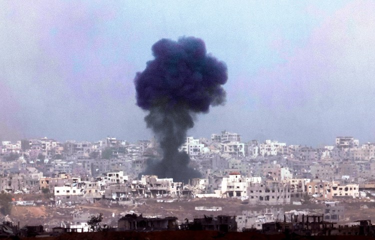 In this photograph taken from southern Israel, smoke billows across destroyed buildings in the Gaza Strip during an Israeli bombing on May, 27, 2025. (Photo: AFP/Jack Guez)