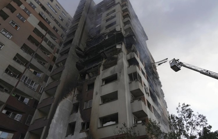 A rescue crane rises next to a residential building struck in Israeli attacks on the Iranian capital Tehran on June 13, 2025.