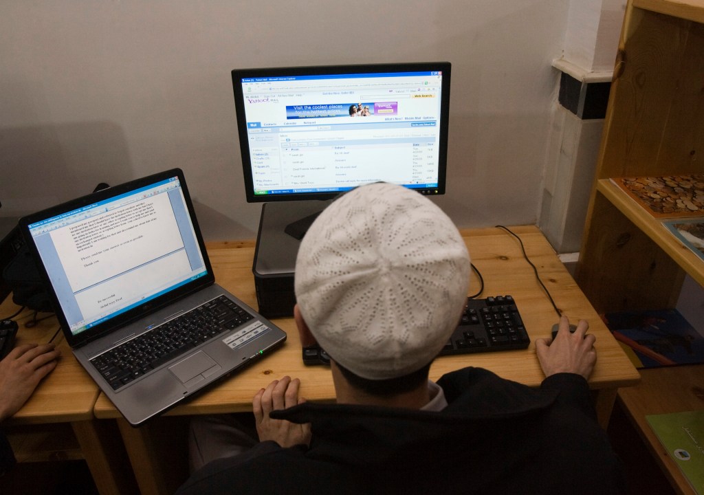 An Afghan man uses the internet at the Lincoln U.S. support library in Herat December 13, 2009.